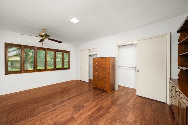 1908 Milam St, Columbus, TX 78934 - unfurnished bedroom featuring two closets, dark wood-type flooring, and a ceiling fan