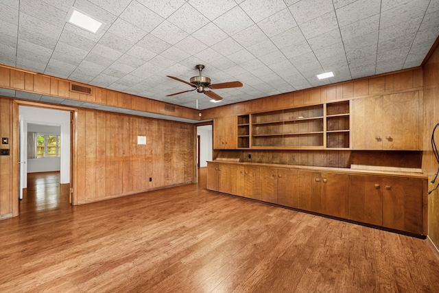 1908 Milam St, Columbus, TX 78934 - unfurnished room featuring wood walls, a ceiling fan, light wood-style flooring, and built in shelves