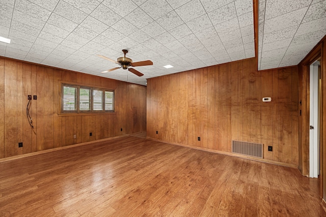 1908 Milam St, Columbus, TX 78934 - unfurnished room with a ceiling fan, wood finished floors, and wooden walls