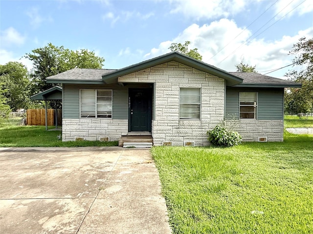 1302 Muncy St, El Campo, TX 77437 - view of front of home with stone siding and roof with shingles