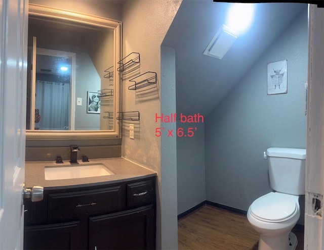 5155 Verdenbruk Dr, Houston, TX 77066 - bathroom featuring vanity, vaulted ceiling, and wood finished floors