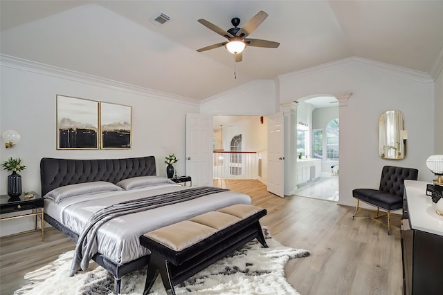 20531 Spring Rose Dr, Katy, TX 77450 - bedroom with ornate columns, vaulted ceiling, light wood-style floors, arched walkways, and ornamental molding