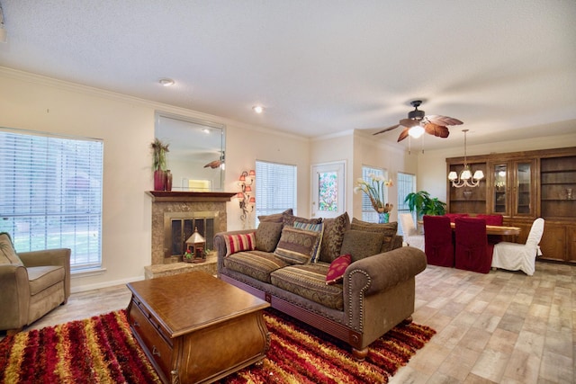 9408 Bassoon Dr, Houston, TX 77025 - living area featuring a ceiling fan, light wood-type flooring, healthy amount of natural light, ornamental molding, and a glass covered fireplace
