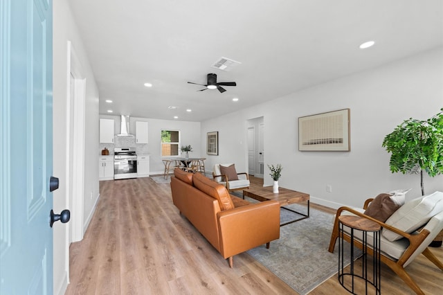 327 E Delz Dr, Houston, TX 77022 - living room featuring recessed lighting, light wood-style floors, and a ceiling fan