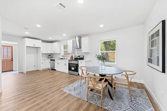 327 E Delz Dr, Houston, TX 77022 - dining space with healthy amount of natural light, light wood-style flooring, and recessed lighting