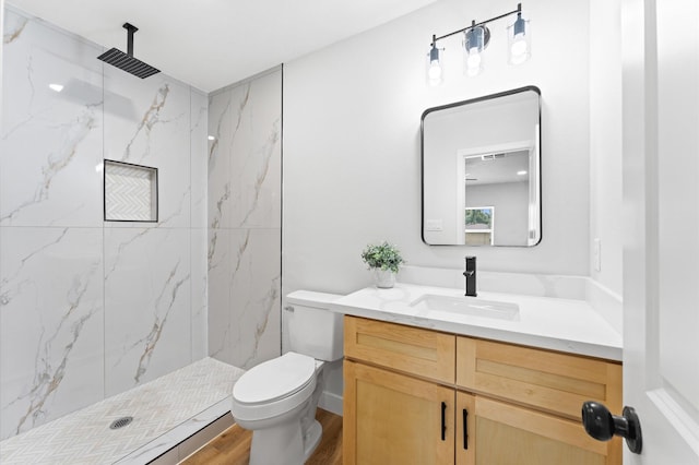 327 E Delz Dr, Houston, TX 77022 - bathroom featuring vanity, a marble finish shower, and wood finished floors