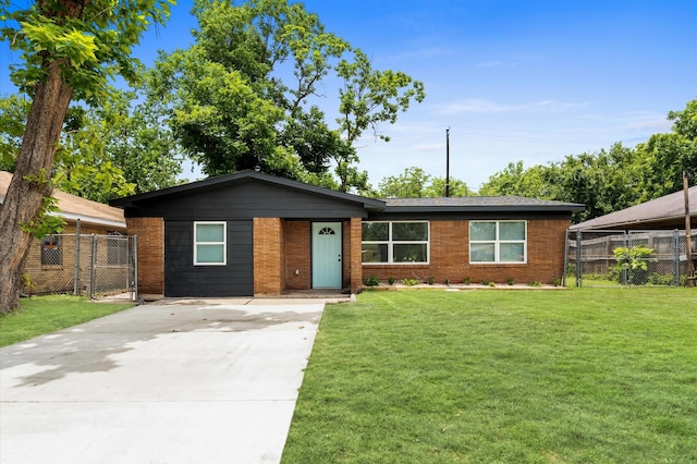327 E Delz Dr, Houston, TX 77022 - view of front of home with concrete driveway, a gate, and brick siding