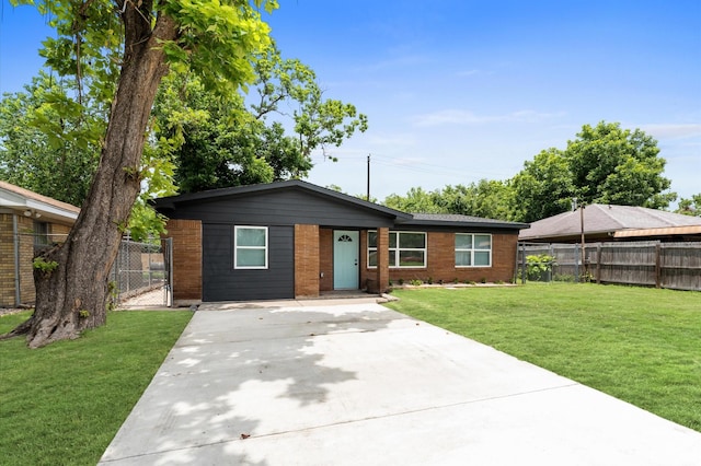 327 E Delz Dr, Houston, TX 77022 - ranch-style home featuring concrete driveway, brick siding, and a gate