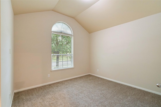 8934 Finnery Dr, Tomball, TX 77375 - carpeted empty room featuring vaulted ceiling and baseboards