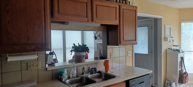 14631 Saint Cloud Dr, Houston, TX 77062 - kitchen with dishwasher, light countertops, washer / clothes dryer, and brown cabinetry
