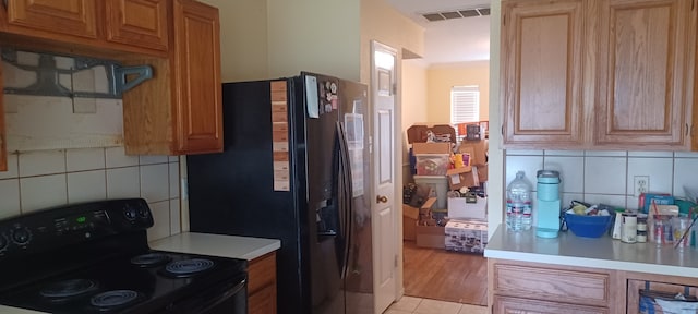14631 Saint Cloud Dr, Houston, TX 77062 - kitchen featuring black appliances, decorative backsplash, light countertops, and light tile patterned floors