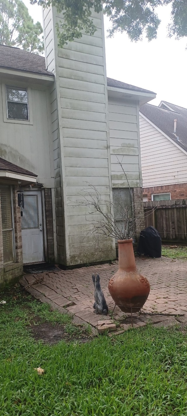 14631 Saint Cloud Dr, Houston, TX 77062 - view of side of home featuring a chimney and a patio area