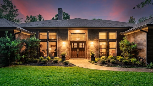 15608 Queen Victoria Ct, Montgomery, TX 77316 - view of front of home featuring a front yard, a chimney, a shingled roof, and brick siding