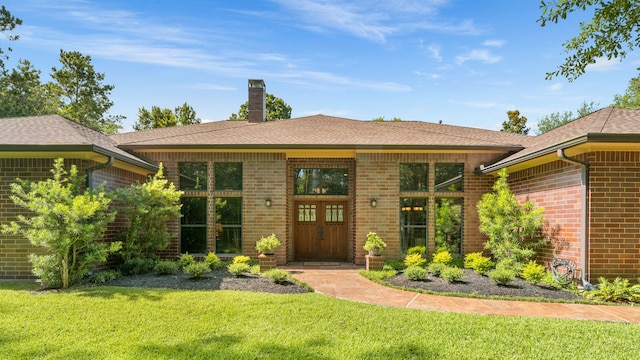 15608 Queen Victoria Ct, Montgomery, TX 77316 - entrance to property with brick siding, a lawn, a chimney, and a shingled roof