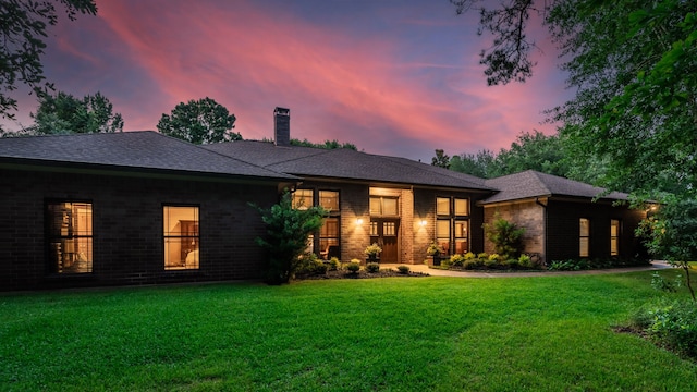 15608 Queen Victoria Ct, Montgomery, TX 77316 - view of front of house featuring a chimney, a lawn, and brick siding