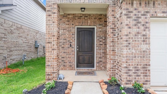 17734 Pensford Way, Tomball, TX 77377 - view of exterior entry featuring brick siding and a garage