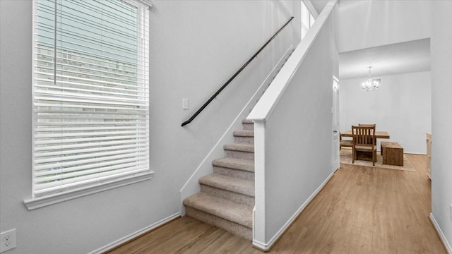 17734 Pensford Way, Tomball, TX 77377 - stairs with wood finished floors, plenty of natural light, and a chandelier