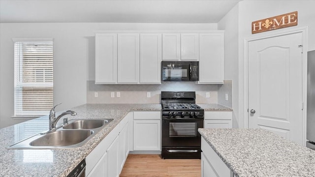 17734 Pensford Way, Tomball, TX 77377 - kitchen featuring black appliances, white cabinetry, and light wood-type flooring