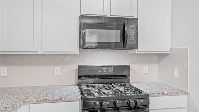 17734 Pensford Way, Tomball, TX 77377 - kitchen with black appliances, decorative backsplash, white cabinets, and light stone countertops