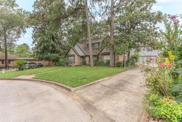 410 Shadywood Cir, Conroe, TX 77304 - view of front of house with a front yard, brick siding, and concrete driveway