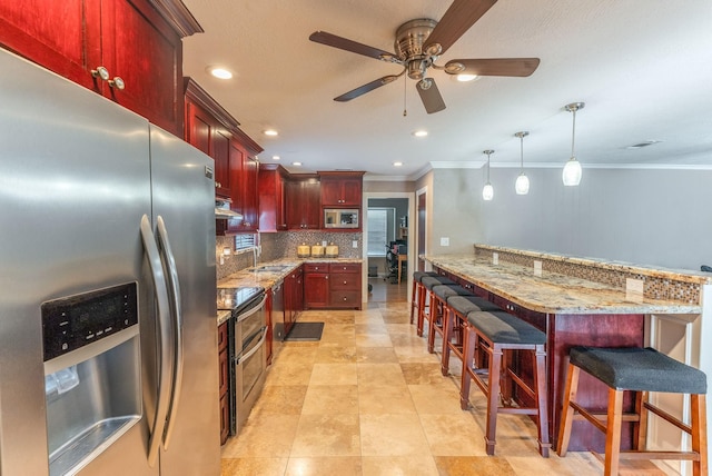 410 Shadywood Cir, Conroe, TX 77304 - kitchen featuring stainless steel appliances, dark brown cabinets, a ceiling fan, crown molding, and backsplash
