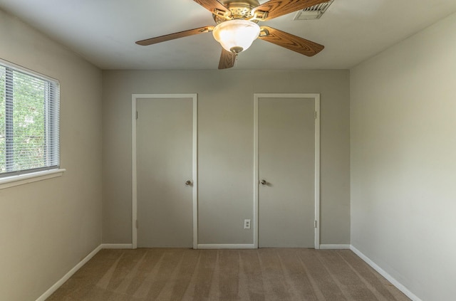 410 Shadywood Cir, Conroe, TX 77304 - unfurnished bedroom with light colored carpet and ceiling fan