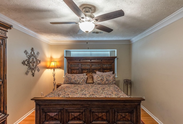 410 Shadywood Cir, Conroe, TX 77304 - bedroom featuring a textured ceiling, light wood-type flooring, ceiling fan, and ornamental molding
