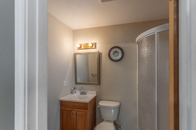 410 Shadywood Cir, Conroe, TX 77304 - bathroom featuring vanity, a shower with door, and a textured ceiling