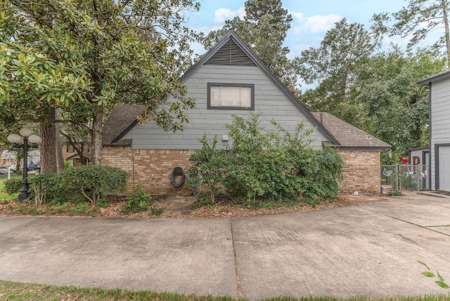 410 Shadywood Cir, Conroe, TX 77304 - view of property exterior with brick siding and roof with shingles