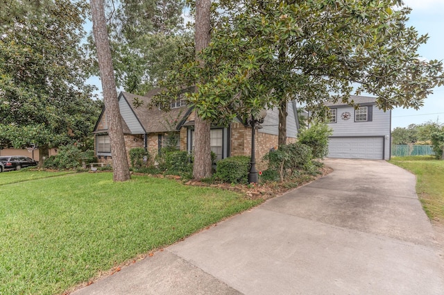 410 Shadywood Cir, Conroe, TX 77304 - view of front of property featuring brick siding, concrete driveway, an attached garage, and a front lawn