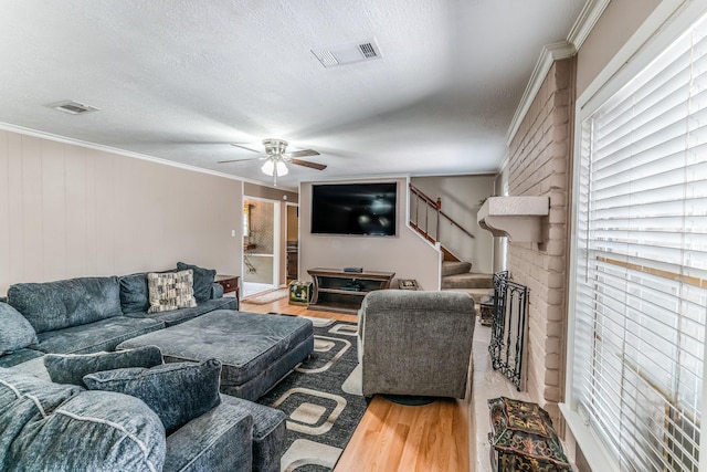410 Shadywood Cir, Conroe, TX 77304 - living area with wood finished floors, a ceiling fan, crown molding, stairway, and a textured ceiling