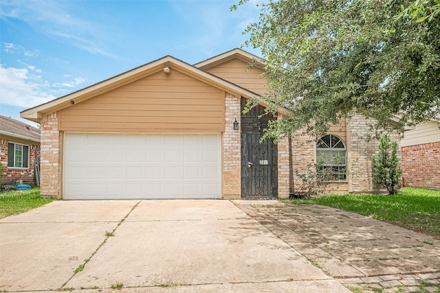 511 Walston Ln, Houston, TX 77060 - view of front of house featuring driveway, brick siding, and a garage