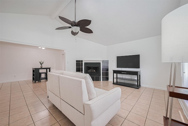 511 Walston Ln, Houston, TX 77060 - living room featuring light tile patterned floors, a ceiling fan, beamed ceiling, a fireplace, and high vaulted ceiling