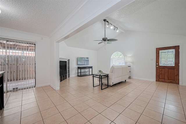 511 Walston Ln, Houston, TX 77060 - living area with a textured ceiling, light tile patterned floors, ceiling fan, a fireplace, and lofted ceiling