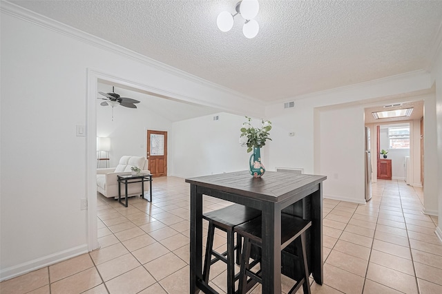 511 Walston Ln, Houston, TX 77060 - dining area featuring light tile patterned floors, a textured ceiling, and ornamental molding