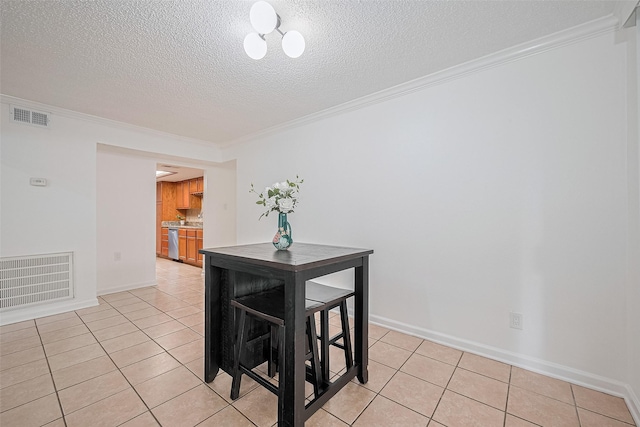 511 Walston Ln, Houston, TX 77060 - dining area with ornamental molding, light tile patterned floors, and a textured ceiling
