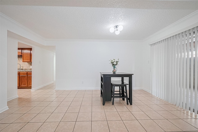 511 Walston Ln, Houston, TX 77060 - dining area with crown molding, light tile patterned flooring, and a textured ceiling