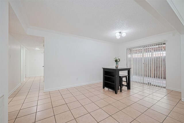 511 Walston Ln, Houston, TX 77060 - dining space featuring a textured ceiling, ornamental molding, and light tile patterned floors