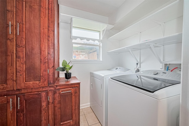 511 Walston Ln, Houston, TX 77060 - laundry room with independent washer and dryer, light tile patterned floors, and cabinet space