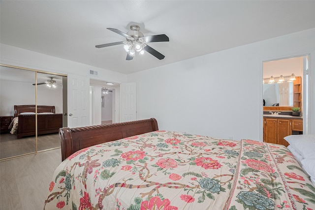 511 Walston Ln, Houston, TX 77060 - bedroom featuring light wood-style flooring, a closet, ceiling fan, and ensuite bathroom