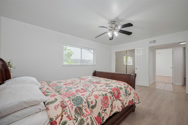 511 Walston Ln, Houston, TX 77060 - bedroom with multiple windows, a closet, light wood-type flooring, and a ceiling fan