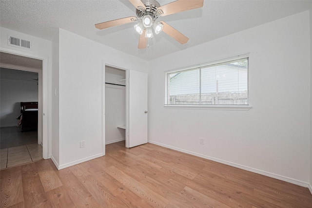 511 Walston Ln, Houston, TX 77060 - unfurnished bedroom with light wood-type flooring, a closet, and a ceiling fan