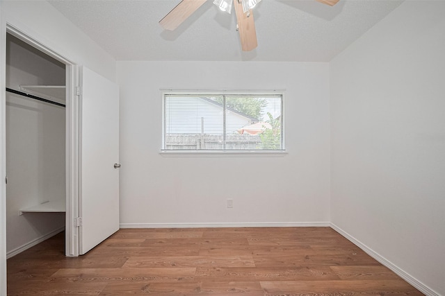 511 Walston Ln, Houston, TX 77060 - unfurnished bedroom featuring light wood-style floors, a ceiling fan, and a closet