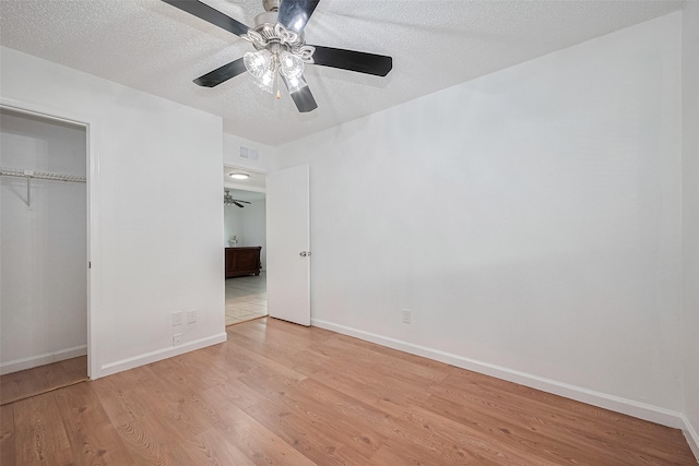 511 Walston Ln, Houston, TX 77060 - unfurnished bedroom with light wood-type flooring, a closet, a textured ceiling, and ceiling fan