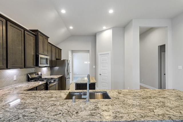 14715 Poplar Lake Trl, Cypress, TX 77429 - kitchen with stainless steel appliances, light stone counters, dark brown cabinets, tasteful backsplash, and lofted ceiling