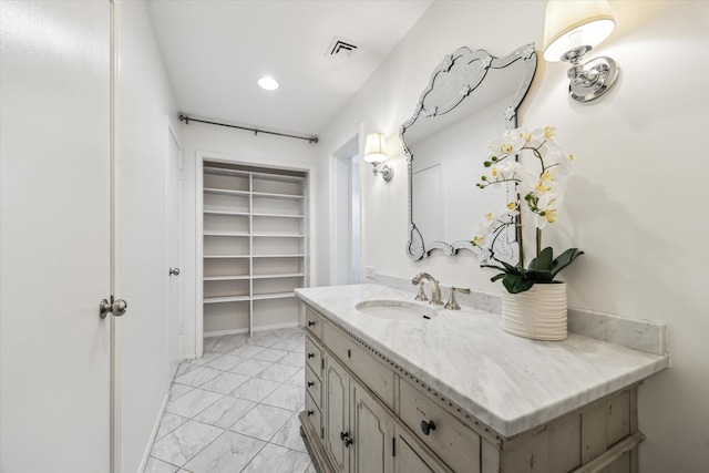 9333 Memorial Dr Unit 301, Houston, TX 77024 - bathroom with marble finish floors, vanity, a walk in closet, recessed lighting, and built in features