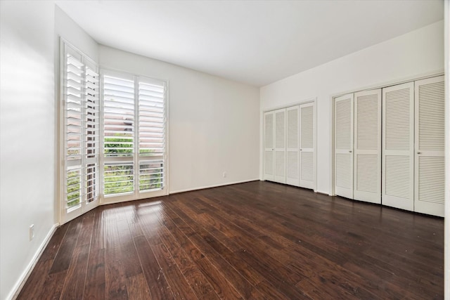 9333 Memorial Dr Unit 301, Houston, TX 77024 - unfurnished bedroom featuring multiple closets and dark wood finished floors