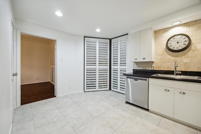 9333 Memorial Dr Unit 301, Houston, TX 77024 - kitchen with dishwasher, dark countertops, white cabinetry, decorative backsplash, and light tile patterned floors
