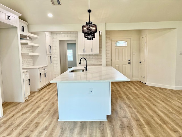 5030 Glenvalley Dr, La Porte, TX 77571 - kitchen with backsplash, light wood-style floors, white cabinets, pendant lighting, and recessed lighting