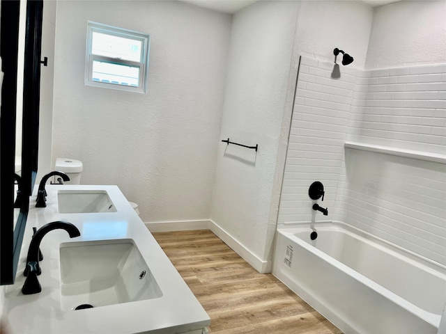 5030 Glenvalley Dr, La Porte, TX 77571 - full bathroom featuring wood finished floors, bathing tub / shower combination, double vanity, and a textured wall